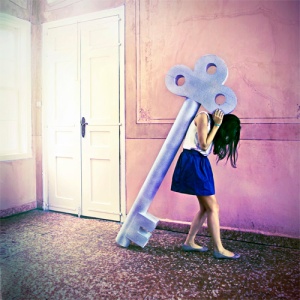 girl carrying huge key